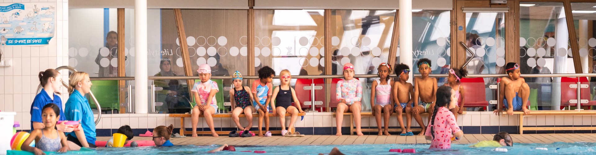 Group of children learning how to swim