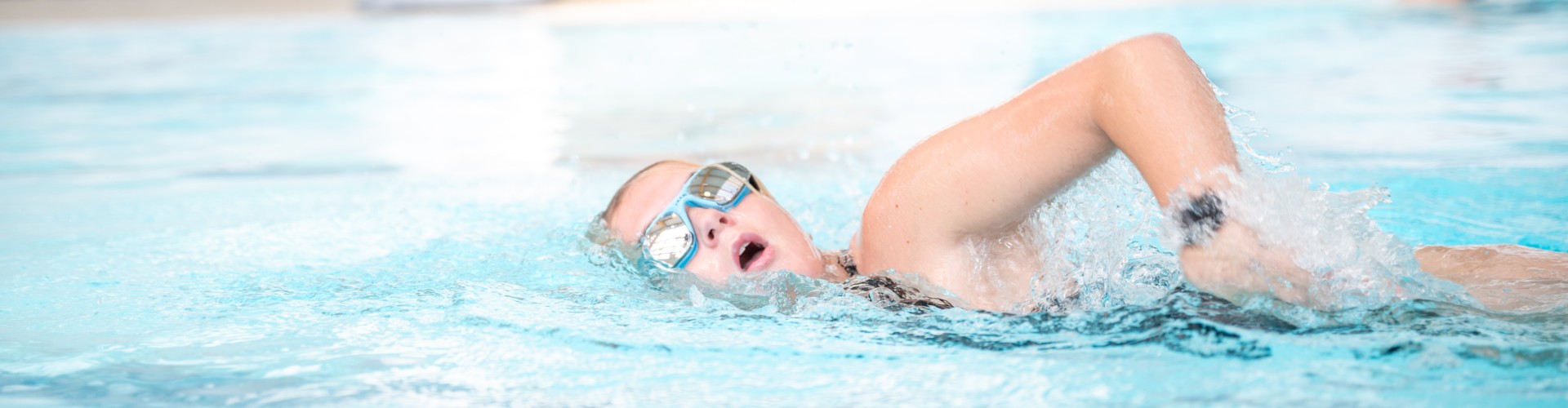 Girl doing front crawl in pool